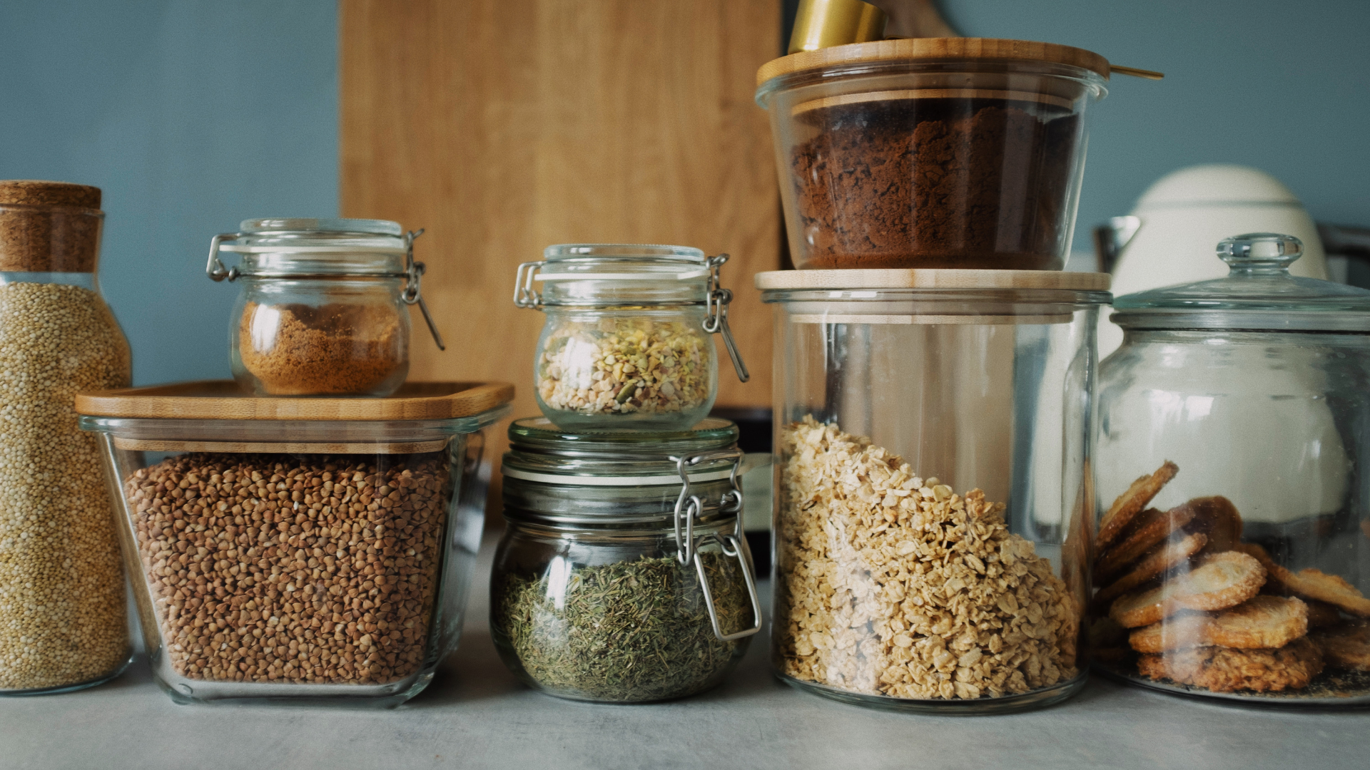Clear glass jars with brown grains on kitchen countertop
