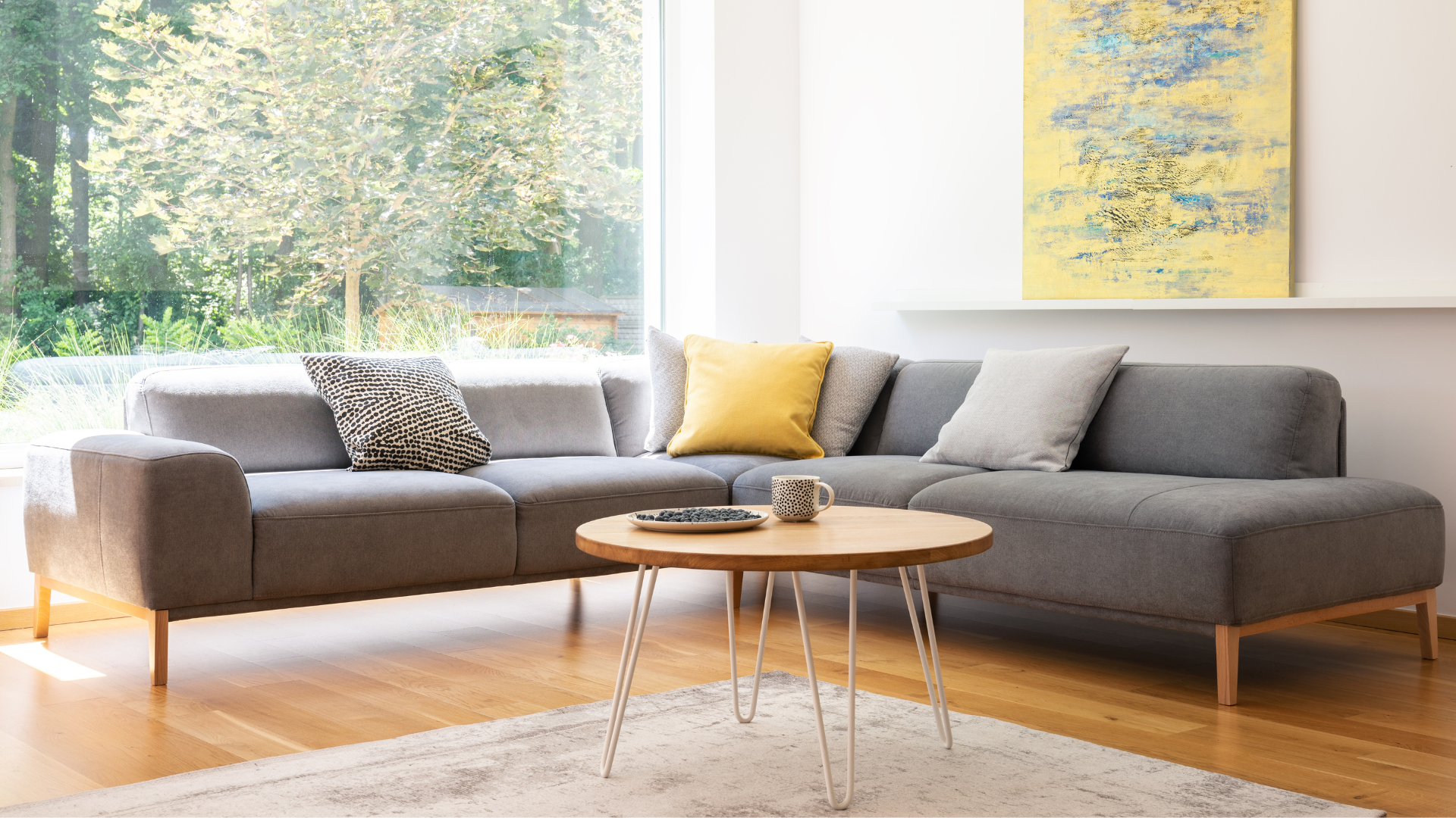 Modern grey sectional sofa and round coffee table
