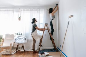 Man and woman work together to complete a living room renovation