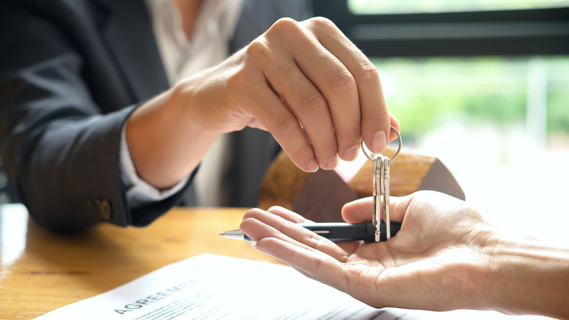 Real Estate Agent Hands Home Buyer The Keys To Their New Home