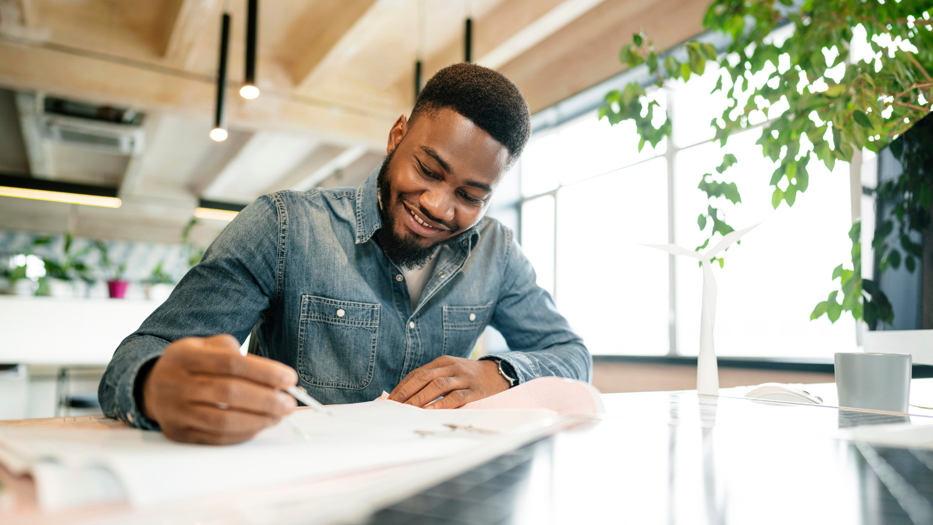 African American Man Happily Signs An Offer For A House