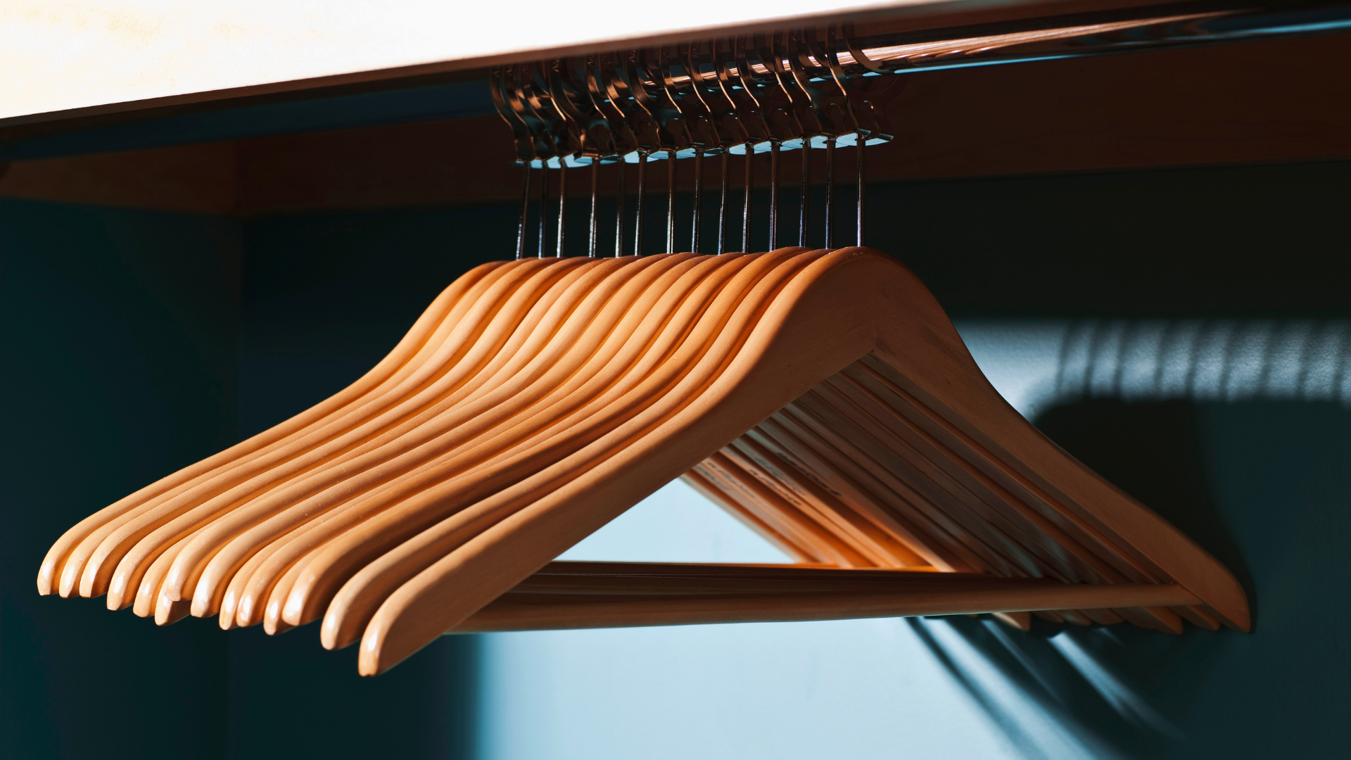 Brown wooden clothes hangers in closet