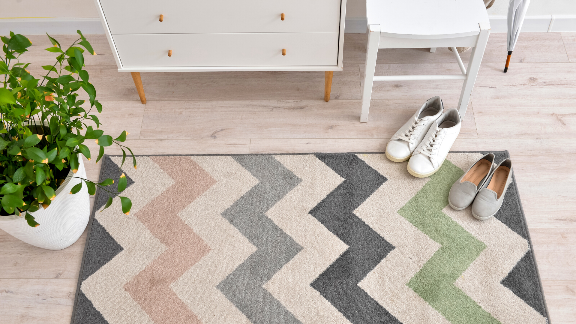 Multicolored chevron rug on whitewashed luxury vinyl plank flooring
