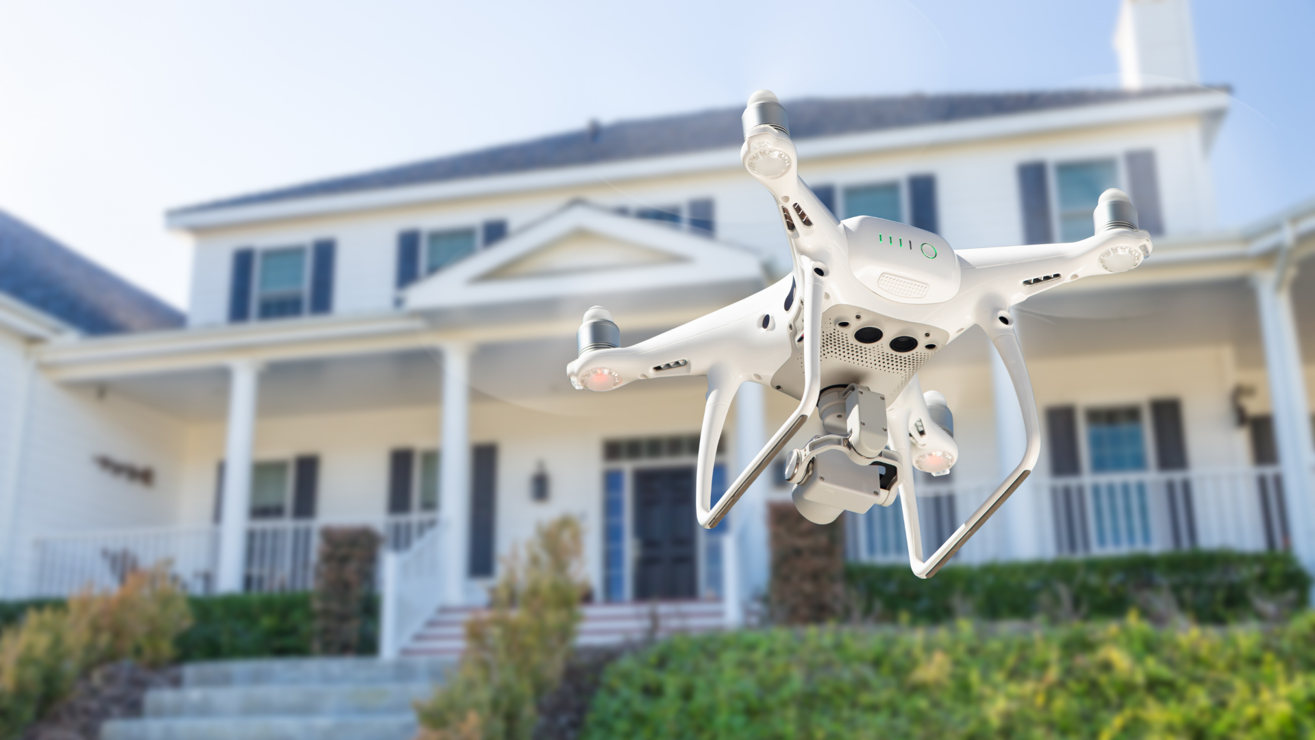 Drone quadcopter taking footage of a home for real estate videography